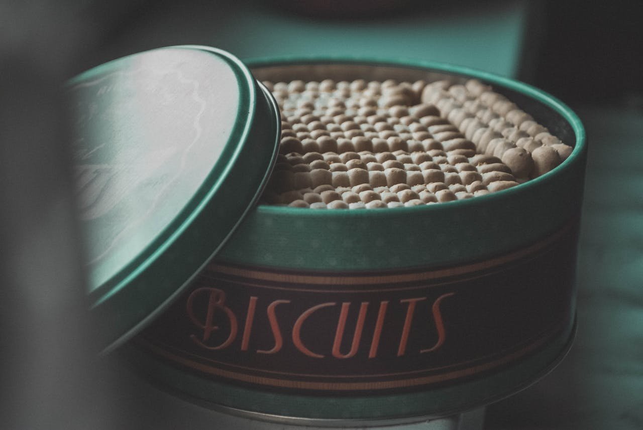 The Art of Drawing Readers In: Your attractive post title goes here A classic tin filled with biscuits, creating a vintage and cozy feel.